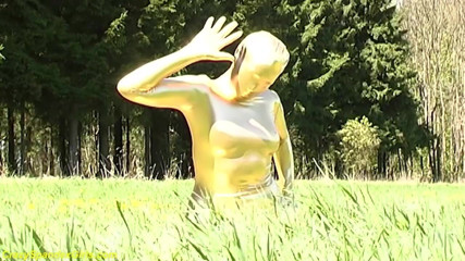 Fetish Islands: Sexy ebony babe in skintight golden spandex catsuit posing outdoor