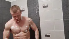 Muscular guy with big dick showering, jerking off and eating cum