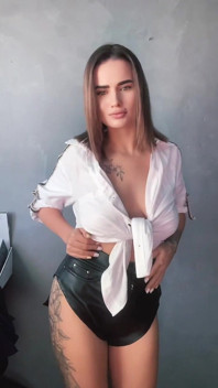 A Brunette in a White Shirt Is Ready to Bare Her Big Breasts