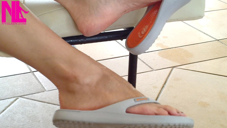 Nyllady: Dangling with Orange Flip Flops in a Swimming Pool