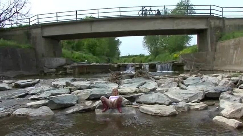 Femdom Austria: Blonde pissing outside in a river