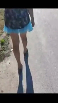 Mel walking on the side of the road