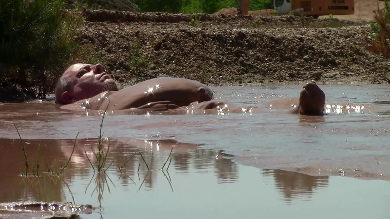 Muddy chubby: Mandi lumpur di lubang pasir dengan lumpur cokelat yang dalam,...