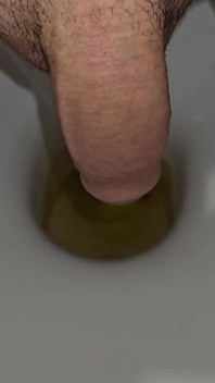 Mężczyzna sika do toalety