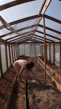 Nude house wife working in the greenhouse