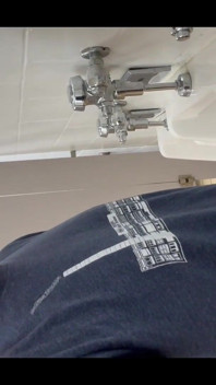 Pissing at a urinal with no dividers.