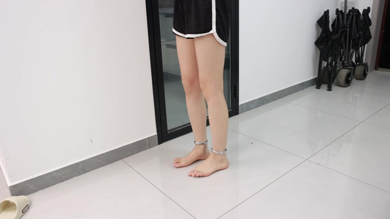 Asian bondage: His Girlfriend, with Her Hands Bound and Wearing Ankle Cuffs,...