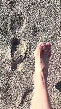 Comparing Size 16 Feet to Sand Prints at the Beach