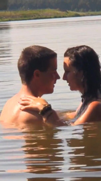 O brunetă frumoasă țâțoasă își invită iubitul să se fută în lac.