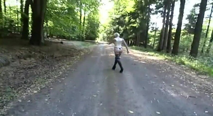 Fetish Desire: Lonely slave in fetish clothes walking in the woods