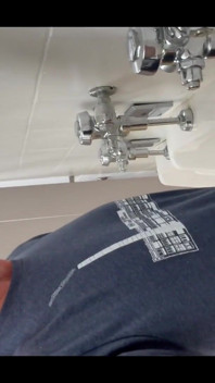 Pissing at a urinal with no dividers.