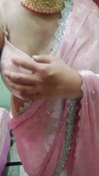 Indian Gay Crossdresser Gaurisissy Pressing and Playing with Her Big Boobs Looking in Pink Saree Looking Like a Housewife