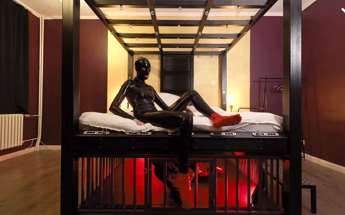 Rubber pervs: Rubber Nights: the Rubber Slave Rests Tight in a Cage...