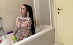 Tattooed Girl with Big Boobs Strips in the Bathtub and Masturbates with a Dildo