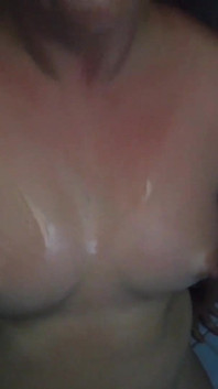 Pregnant Brunette Gets Pissed on Her Oiled Tits