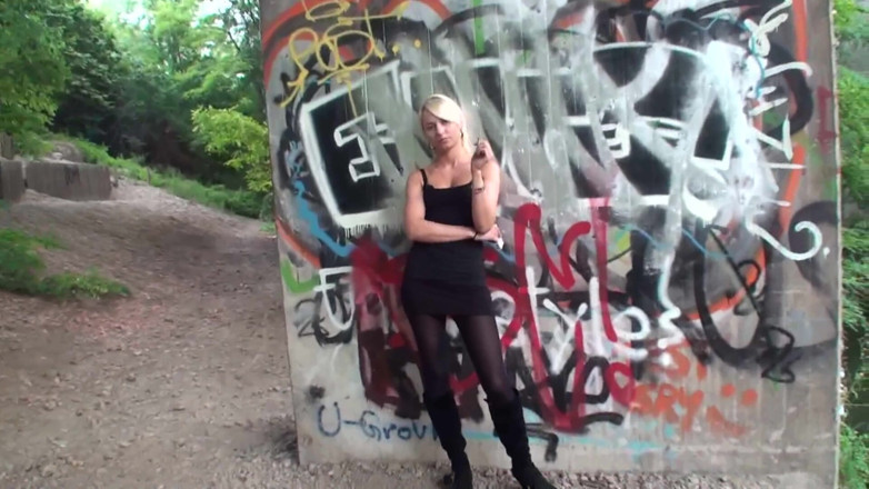 Femdom Austria: Lovely blonde teen smoking a cigarette outdoors