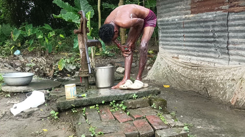 Ranjit Roy: Black mature man bath in desi style. Showing big dick.