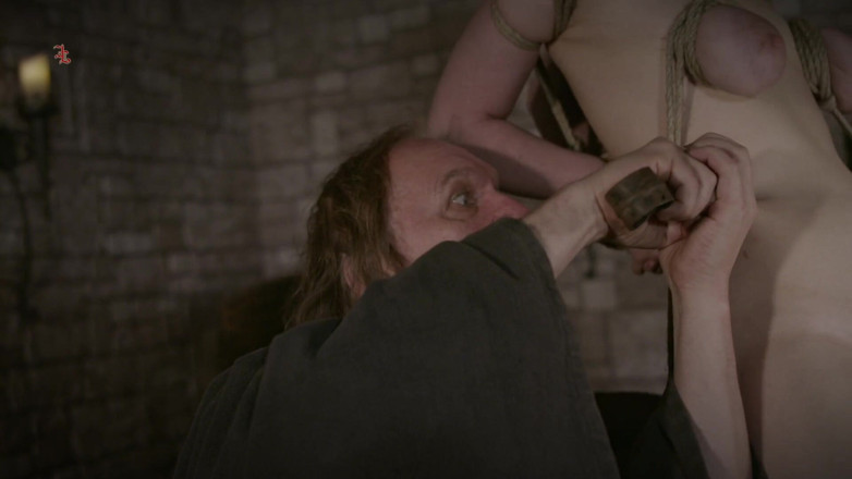 Inquisition and prison world: Accused Witch Writhes on the Sharp Edge of the Wooden...