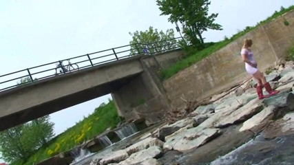 Femdom Austria: Blonde pissing outside in a river