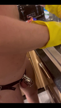 My Chastity Sub Washing the Pots for Me Naked in His Chastity Cage and with His Marigolds on