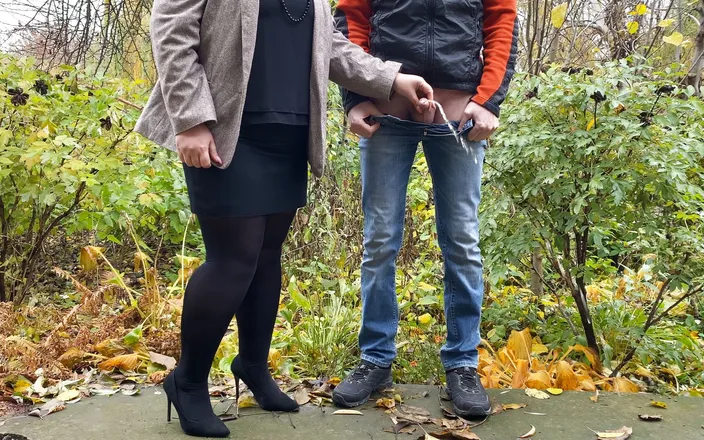 OurFetishLife: Hot in pantyhose and skirt holding guy's cock outdoors while...