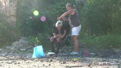 Public Entertainment: Blonde babe gets her hair done outdoors