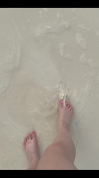 Running My Bare Feet on the White Beach Sand by the Ocean