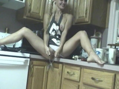Solo Sensations: Slutty chick pokes her cunt with kitchen utensils on counter