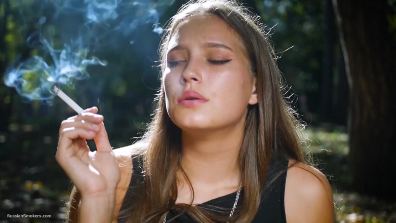 Russian Smokers: Seductive Russian Beauty Smoking Cigarette in Studio