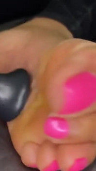 Ebony Girl Gives Her Feet a Massage with a Massage Gun