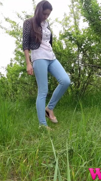 Skinny Brunette Just Had a Pee in the Tall Grass and Now She Puts on Her Jeans and Shoes