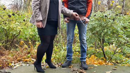 Thumbnail of Hot in pantyhose and skirt holding guy's cock outdoors while pissing