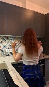 Het jongleurmeisje is hier in een lange universiteitstype uniform rok om haar slipje te laten zien onder haar minirok in de keuken