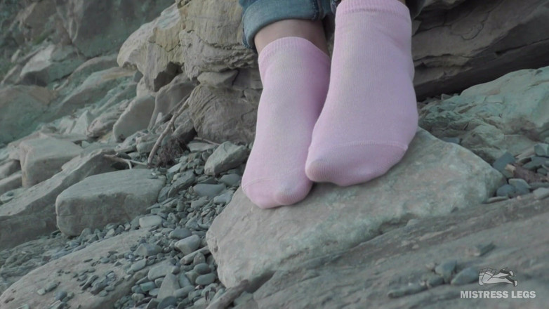 Mistress Legs: Sexy feet in pink ankle socks on the seashore