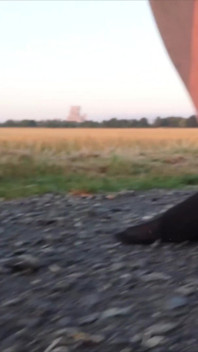 Bright Pantyhose and Beach Shoes in Puddle