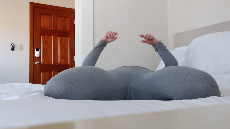 Aurora Willows: Stretching on the bed in yoga pants