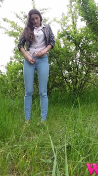 Skinny Brunette Just Had a Pee in the Tall Grass and Now She Puts on Her Jeans and Shoes