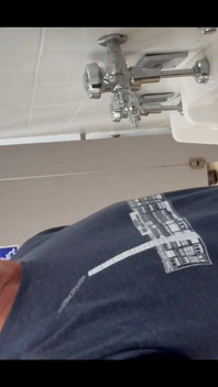 Pissing at a urinal with no dividers.