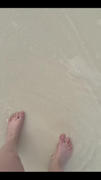 Running My Bare Feet on the White Beach Sand by the Ocean