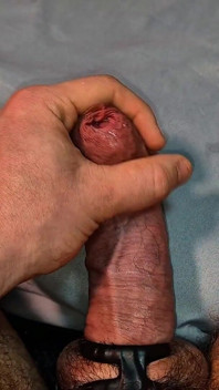 Gros plan, caresses humides avec un prépuce étroit non coupé et un gros pré-éjaculation dégoulinant