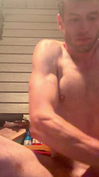 Sentado desnudo, mostrando los biceps, cofre de hombre adulto enorme de cerca
