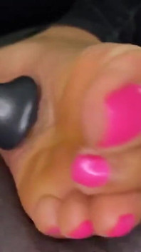 Ebony Girl Gives Her Feet a Massage with a Massage Gun