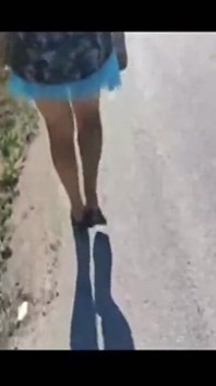 Mel walking on the side of the road