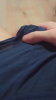 A Young Athletic Guy in Blue Shorts Is Massaging His Penis