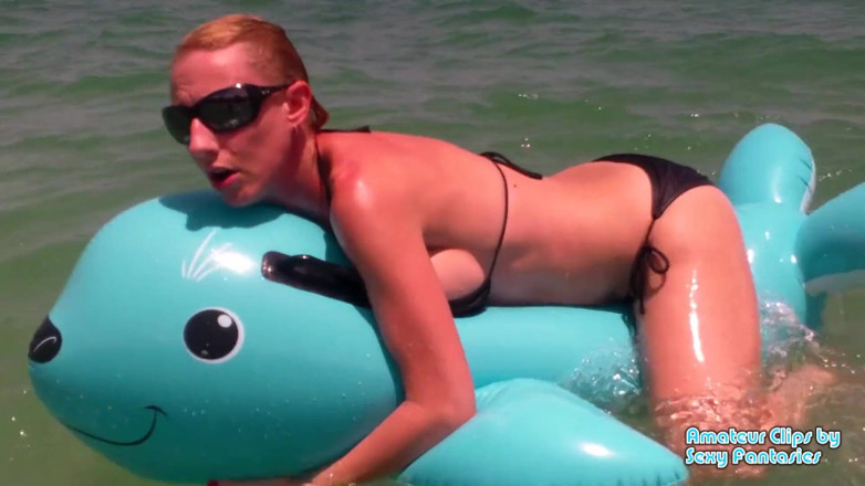 Brittany Lynn: Humping blue inflatable toy in the water at a beach...