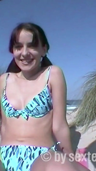A hairy teen shoots her boyfriend with a camera on the beach