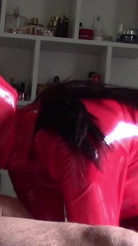 MILF in Red Latex Suit and Patent Leather High Heels Gives a Blowjob with Swallow