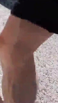 Jon Arteen Walks Barefoot on the Street Outdoors, the Boy Is Barefoot in the Crowded Tram to the Town Center