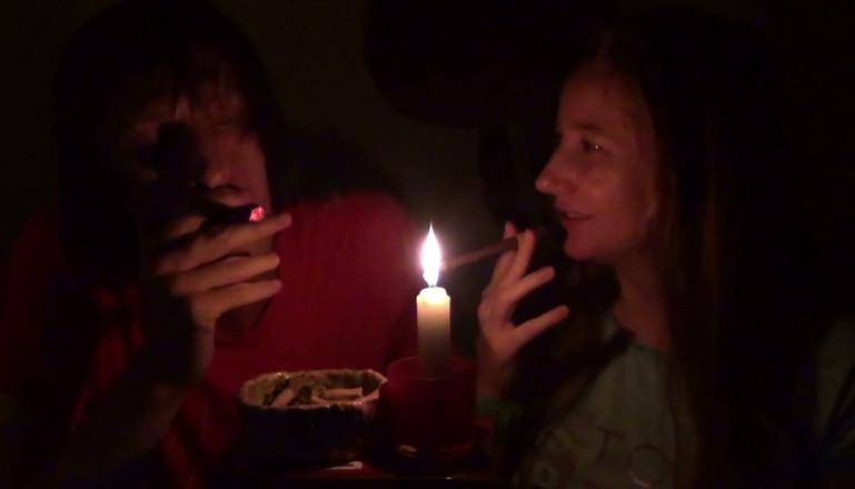 Sensual Lotuses: Couple Smoke Next to Candle