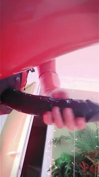 Blonde MILF in Red Latex Rubber Catsuit Teasing with Strap-on